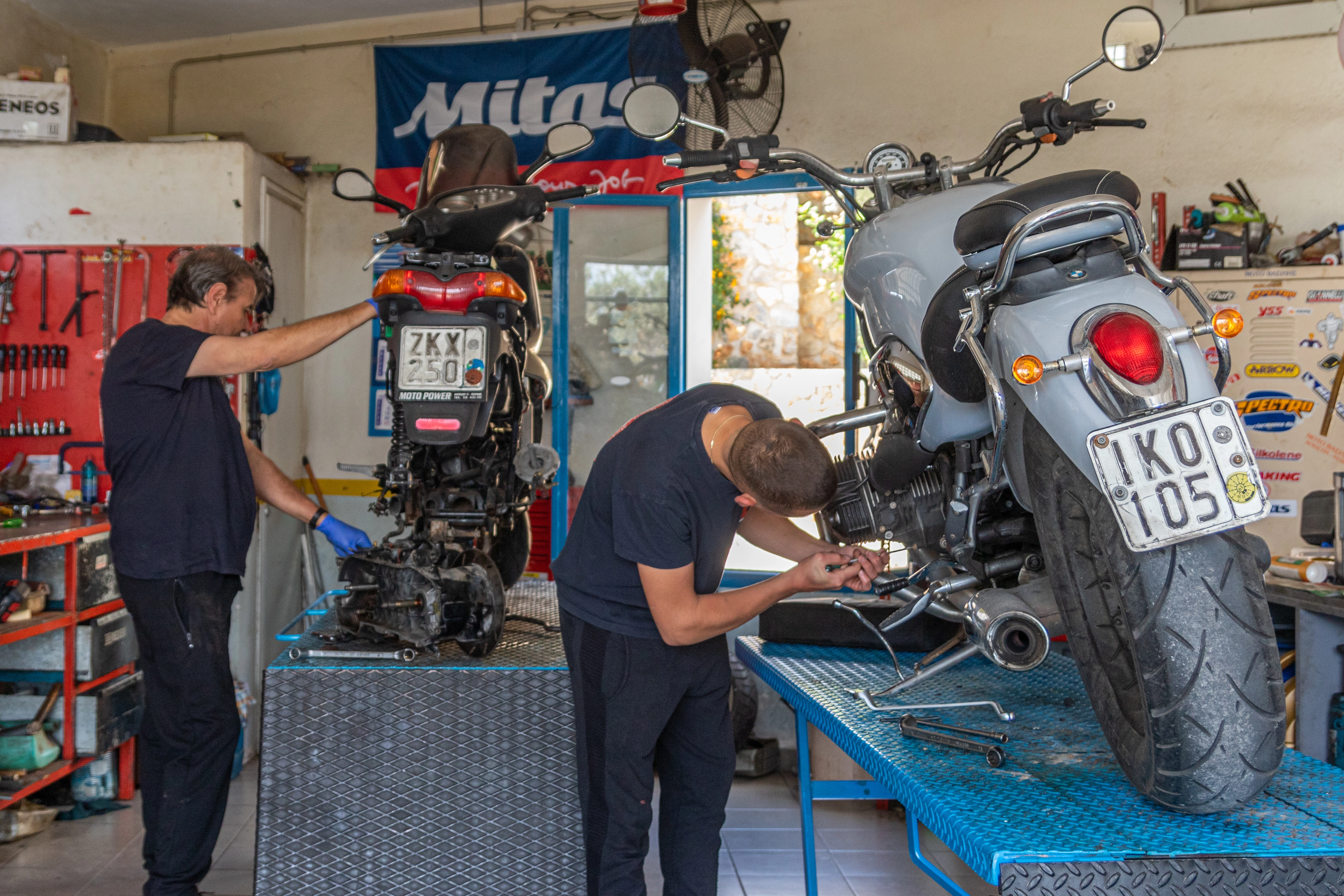 Moto Vasilis crew repairing two motorcycles